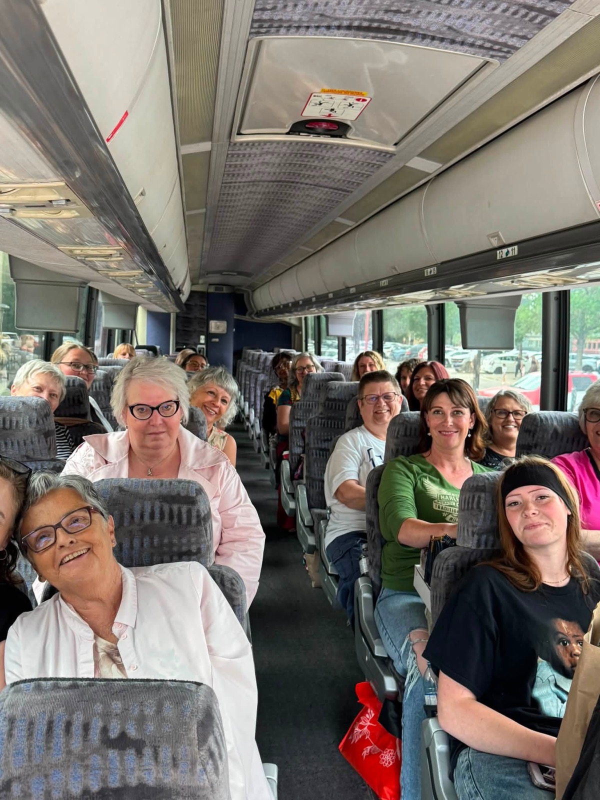 Guests smiling aboard the Little Road Adventures coach